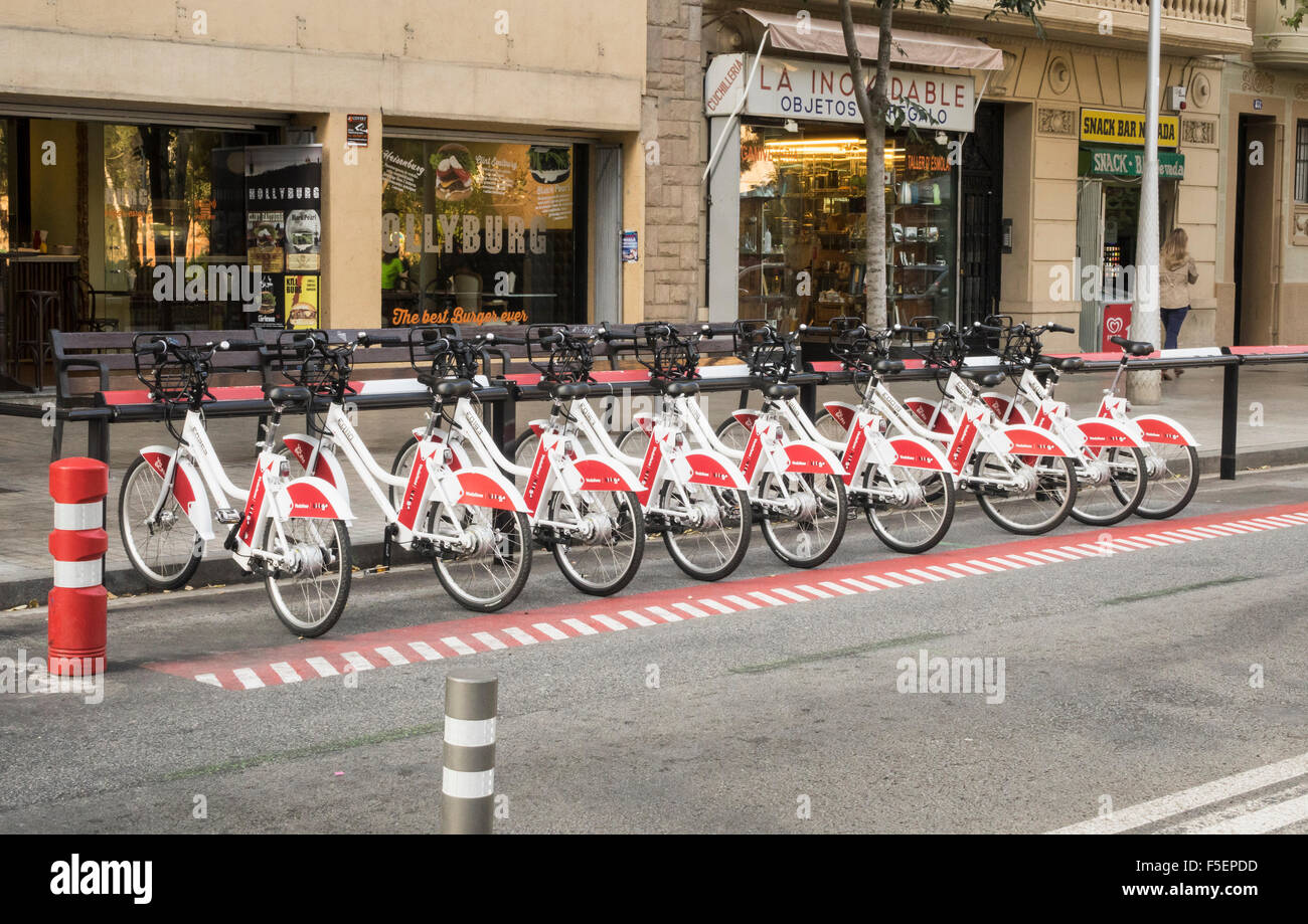 Row of Vodafone sponsored bicycles for rental in Barcelona, Spain Stock Photo