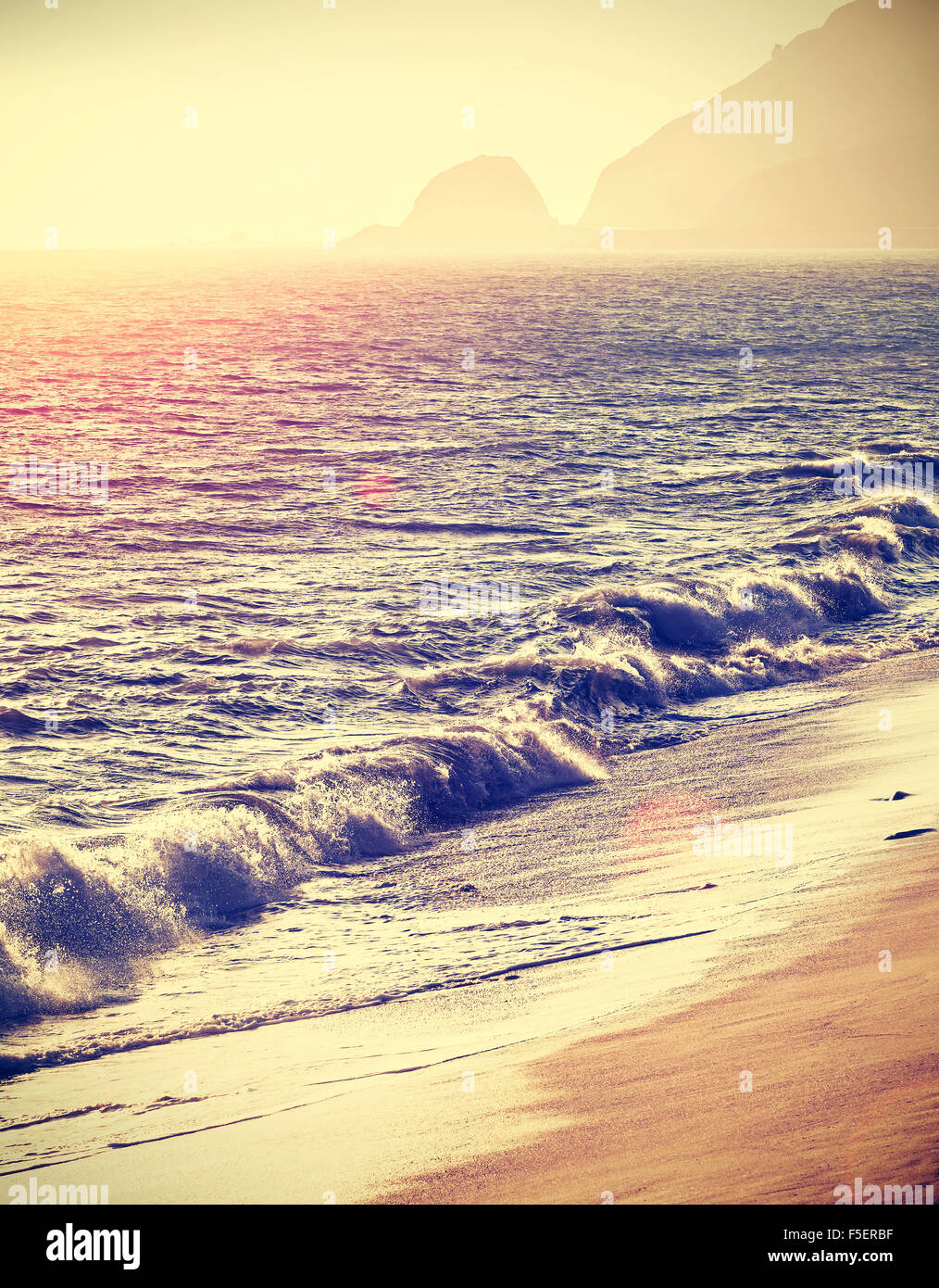 Vintage filtered beach at sunset with flare effect, California, USA. Stock Photo