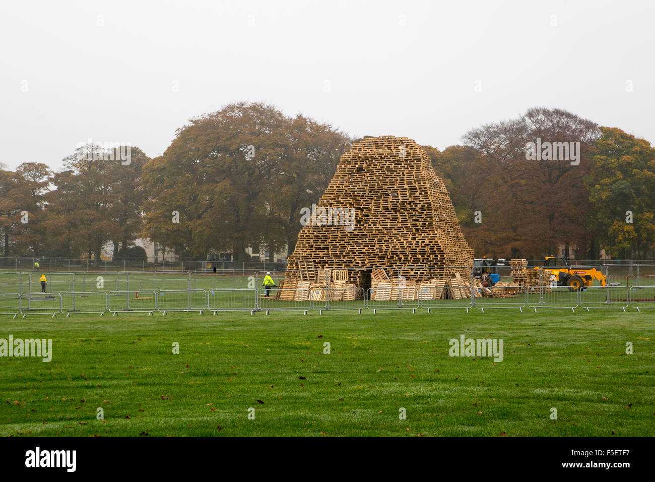 Leeds, UK. 3 November, 2015.  Workers finalise construction of the giant bonfire ready for large public fireworks display in Roundhay Park, Leeds. Credit:  James Copeland/Alamy Live News Stock Photo