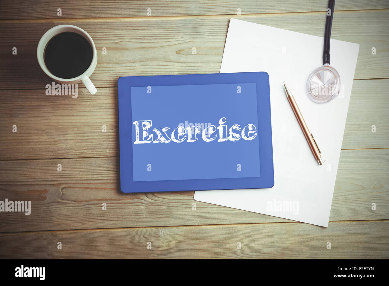 Exercise against high angle view of digital tablet and document with coffee Stock Photo