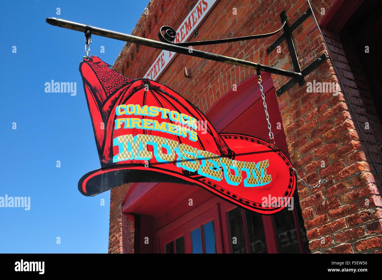 Sign in the shape of a fireman's hat announcing the Comstock Firemen's Museum in Virginia City, Nevada Stock Photo