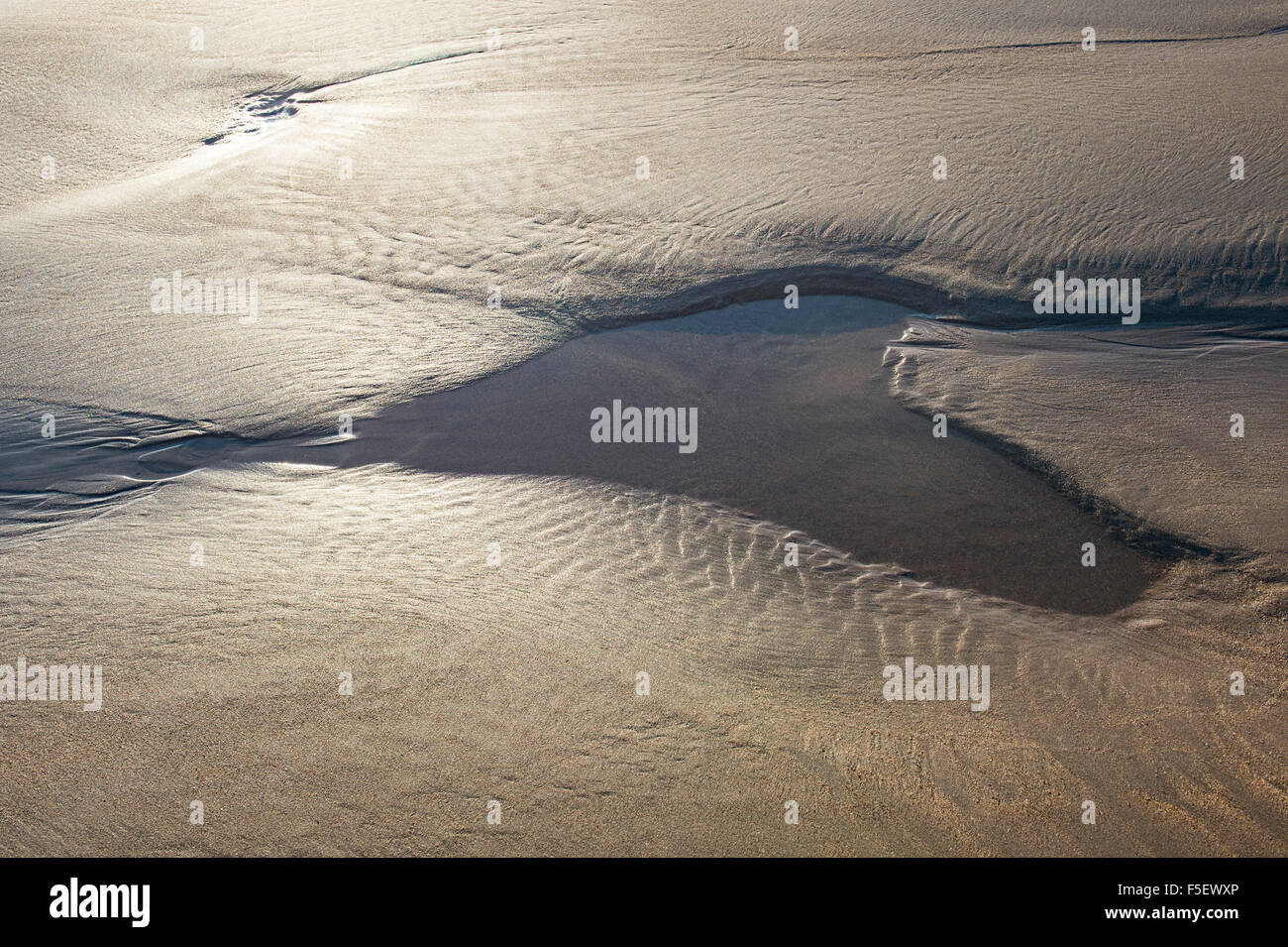 Heart shape pool on the beach filled with sea water at low tide Stock Photo