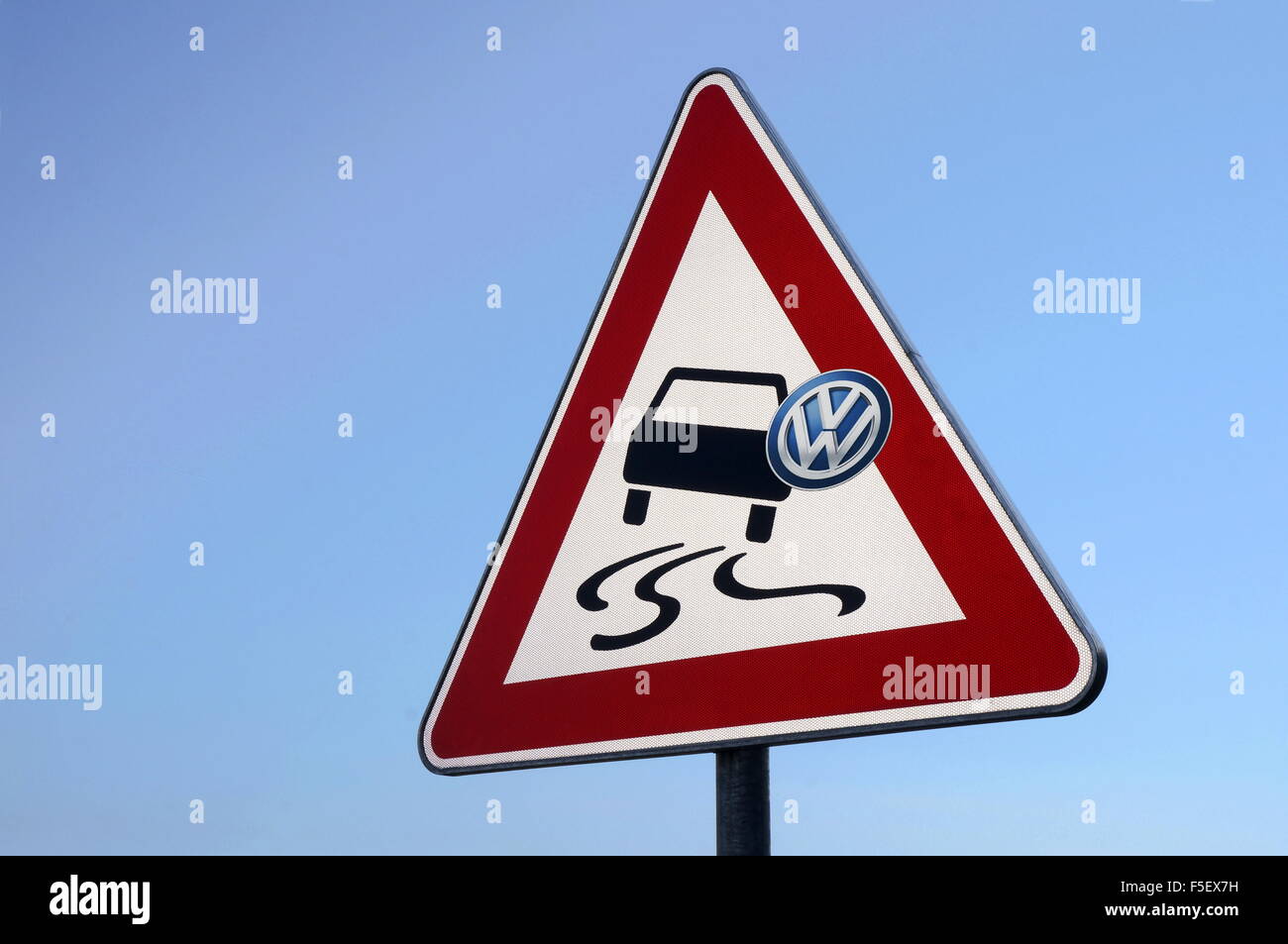 ILLUSTRATION - A sticker with the Volkswagen logo on the traffic risk sign that warns against the risk of skidding and slipping. The photo was taken on 30 August 2015. Photo: S. Steinach - NO WIRE SERVICE - Stock Photo
