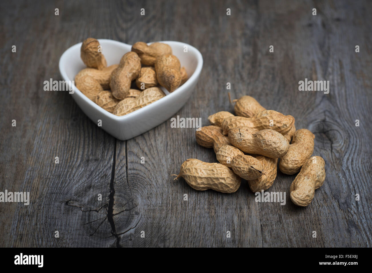 Monkey nuts in a heart shaped bowl Stock Photo Alamy