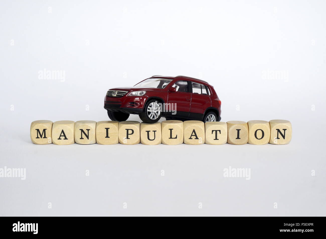 Illustration - A 'Volkswagen Tiguan' of the car brand Volkswagen on cube letters that spell the word manipulation. The photo was taken on 17 October 2015. Photo: S. Steinach - NO WIRE SERVICE - Stock Photo