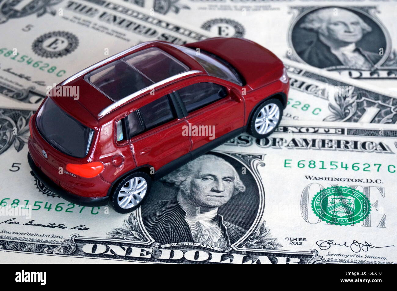 ILLUSTRATION -  A Volkswagen car model 'VW Tiguan' on dollar bills. The photo was taken on 15 October 2015. Photo: S. Steinach - NO WIRE SERVICE - Stock Photo