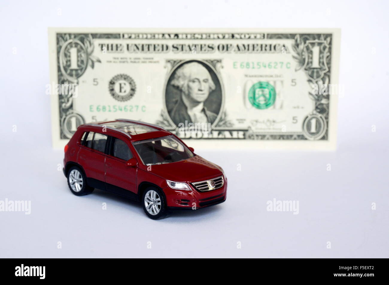 ILLUSTRATION - A Volkswagen car model 'VW Tiguan' in front of a dollar bill. The photo was taken on 15 October 2015. Photo: S. Steinach - NO WIRE SERVICE - Stock Photo