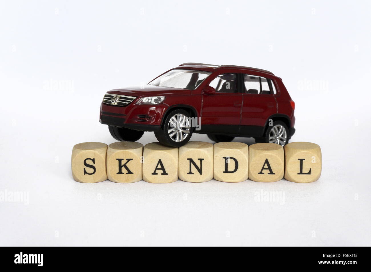 ILLUSTRATION - A Volkswagen car model 'VW Tiguan' on cube letters that write the word 'Scandal'. The photo was taken on 15 October 2015. Photo: S. Steinach - NO WIRE SERVICE - Stock Photo