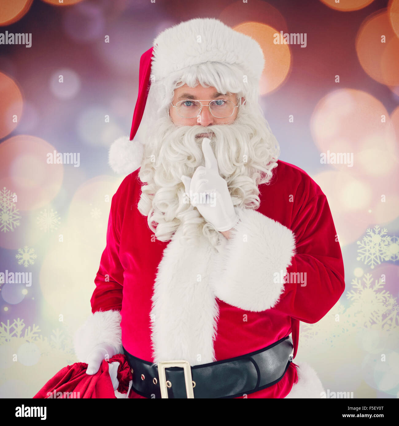 Composite image of santa holding his sack and keeping a secret Stock ...