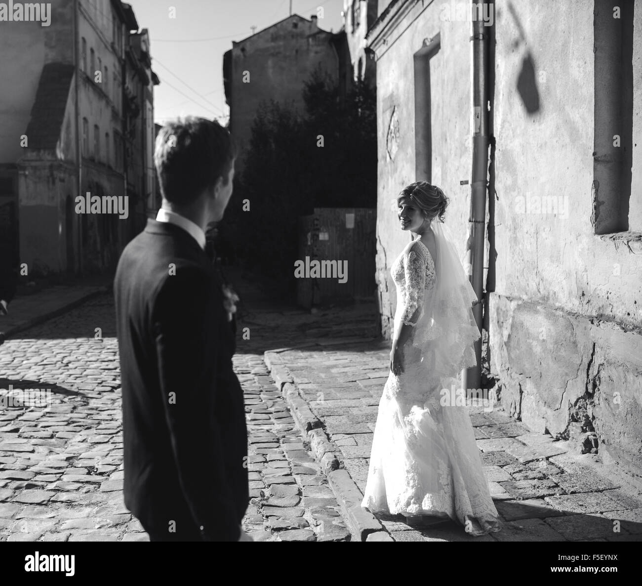bride and groom posing on the streets Stock Photo - Alamy