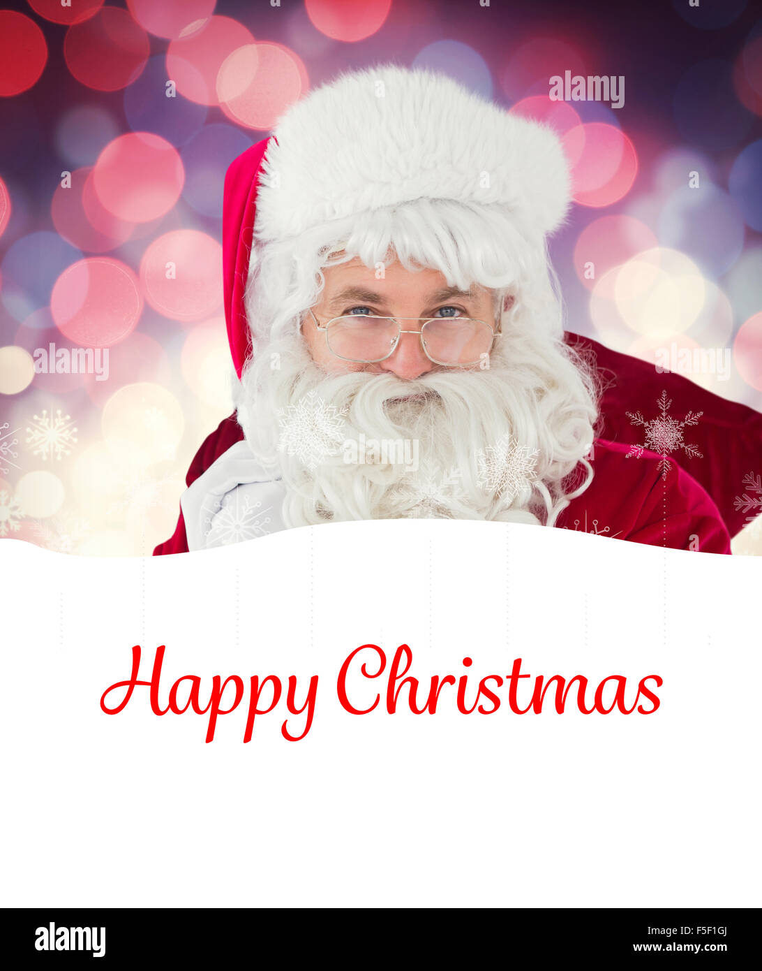 Composite image of happy santa claus holding his sack Stock Photo - Alamy