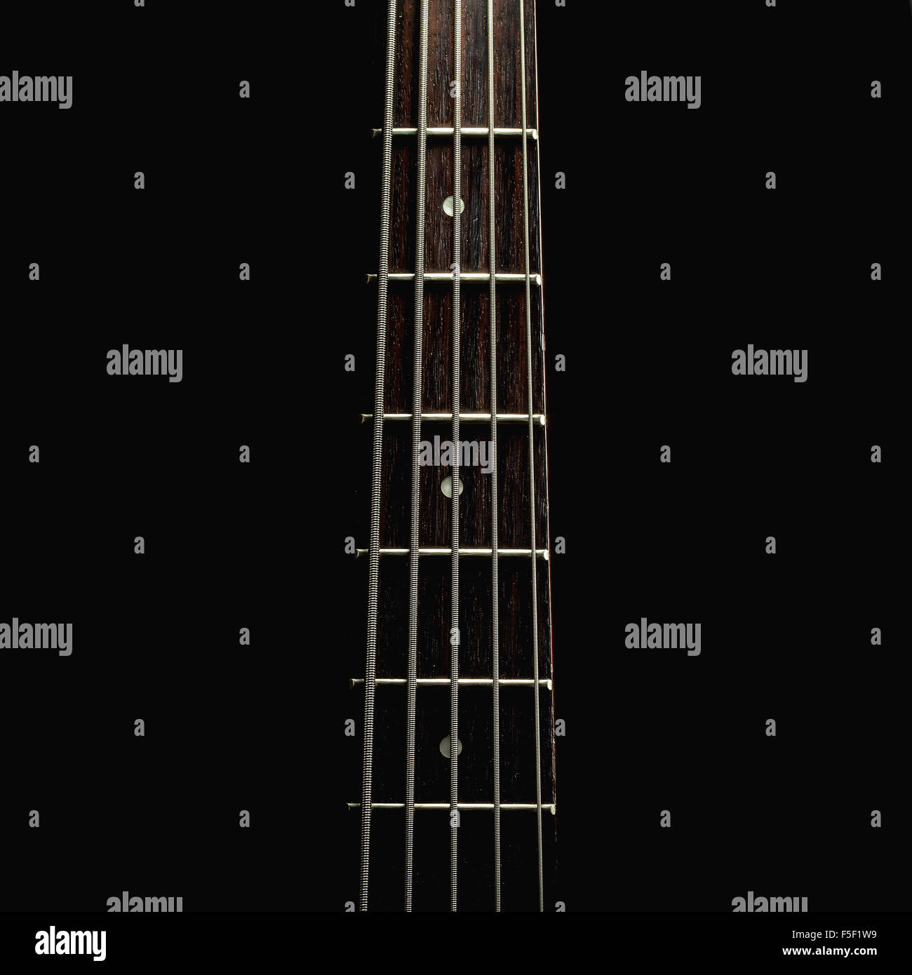 Part of a jazz bass guitar, accentuated shapes with illumination Stock