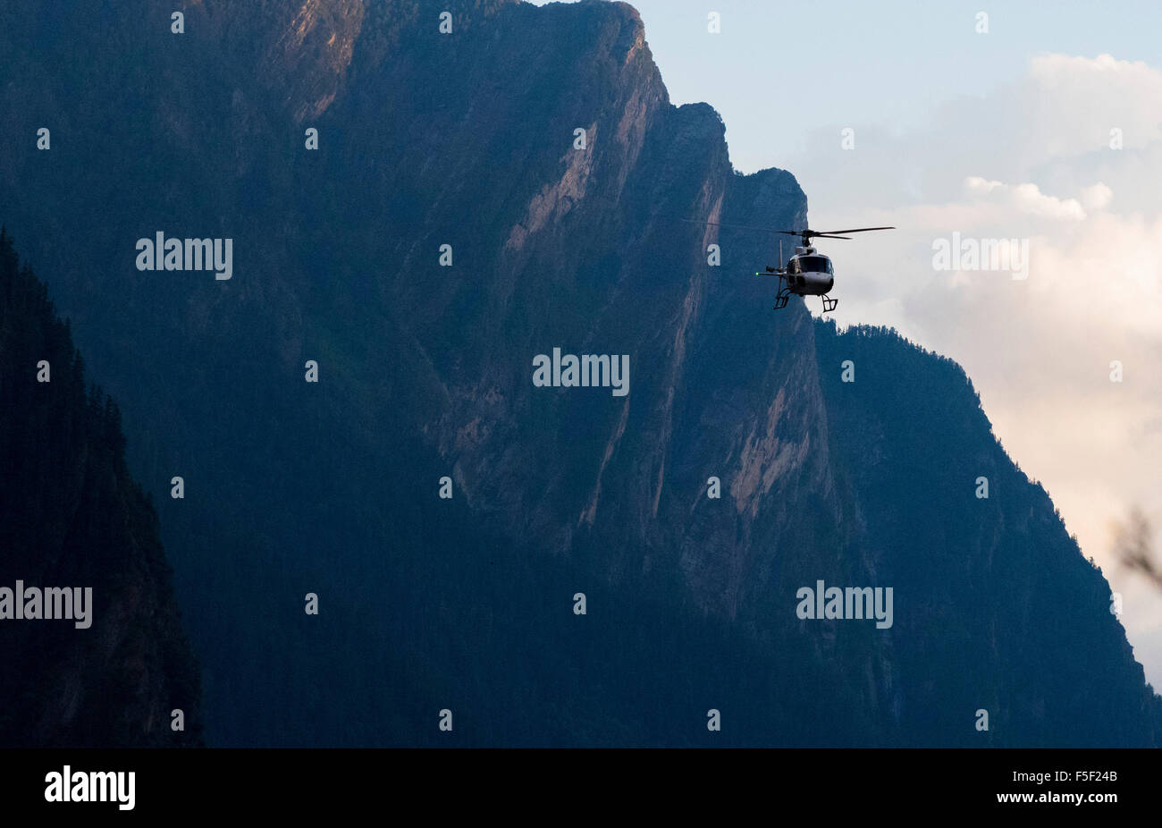 landscape with helicopter over mountains with blue sky Stock Photo