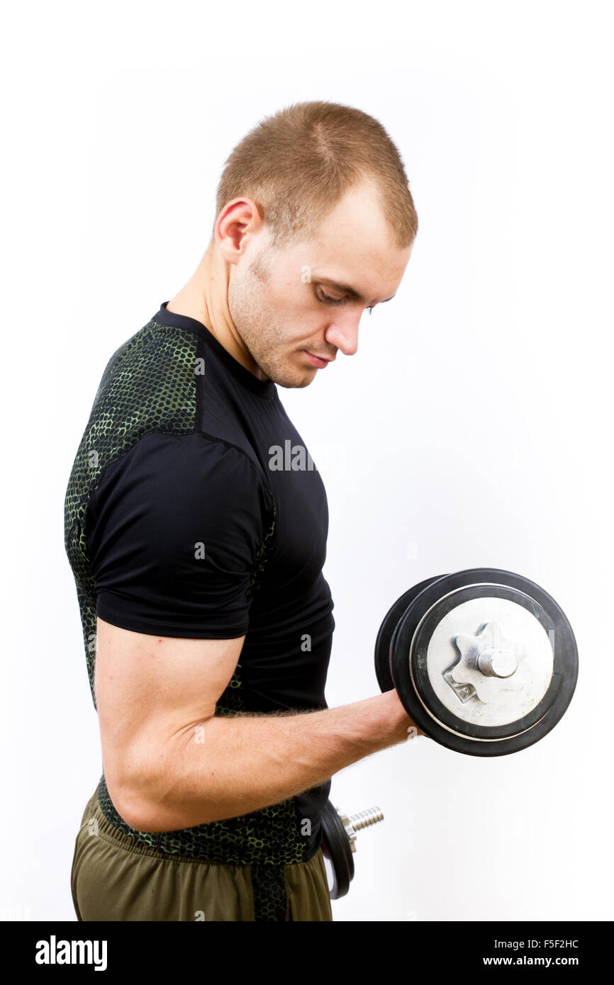 A young man curling a weight on a white background Stock Photo