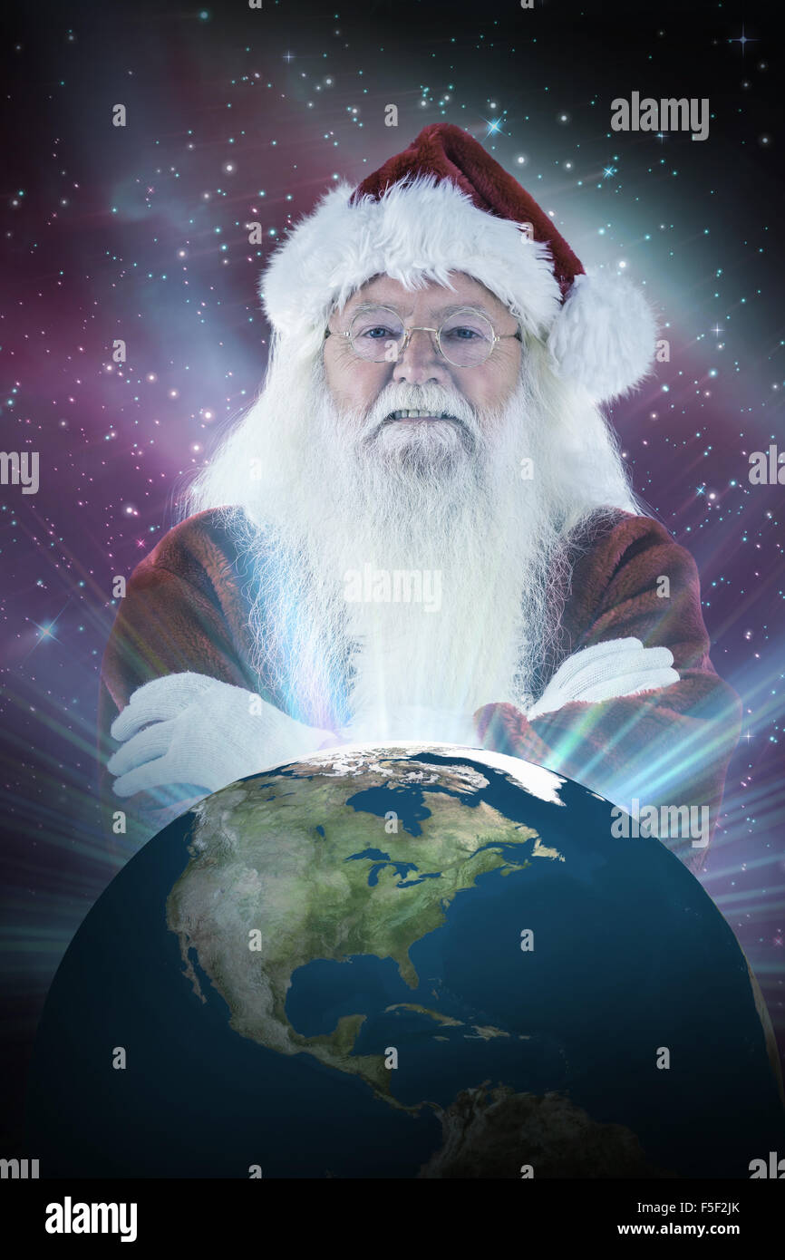 Composite image of santa smiles with folded arms Stock Photo - Alamy
