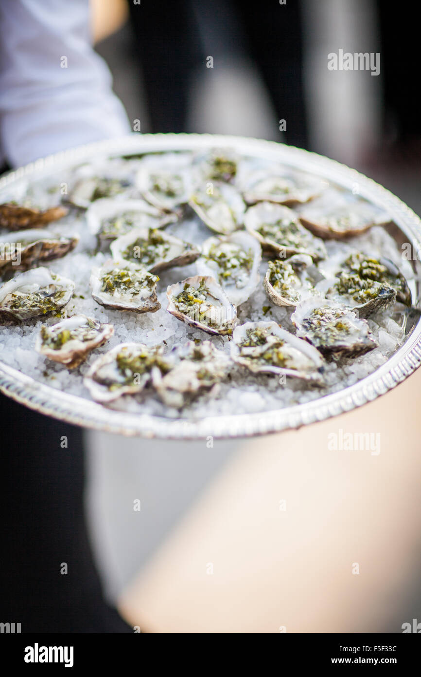 Oysters on a half shell served on a silver platter Stock Photo