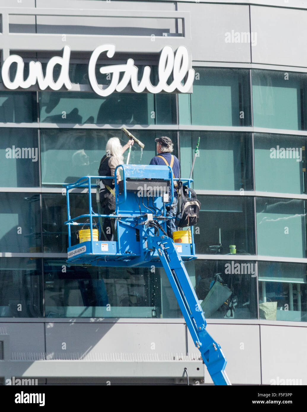 Window washers cleaning windows at Dundas Square in Toronto Ontario Canada Stock Photo