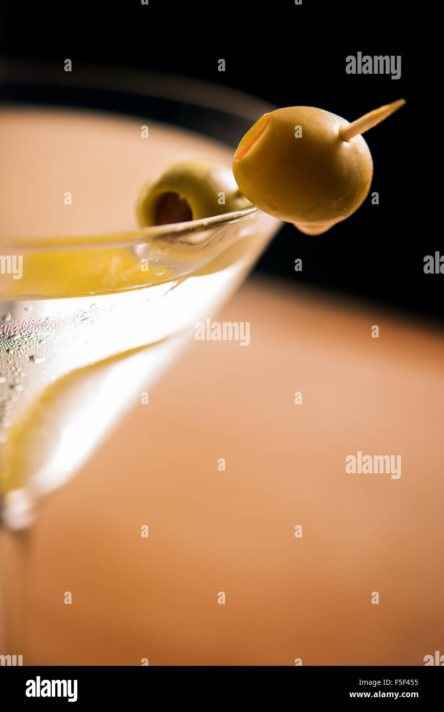 A garnish of an olive on a martini glass Stock Photo