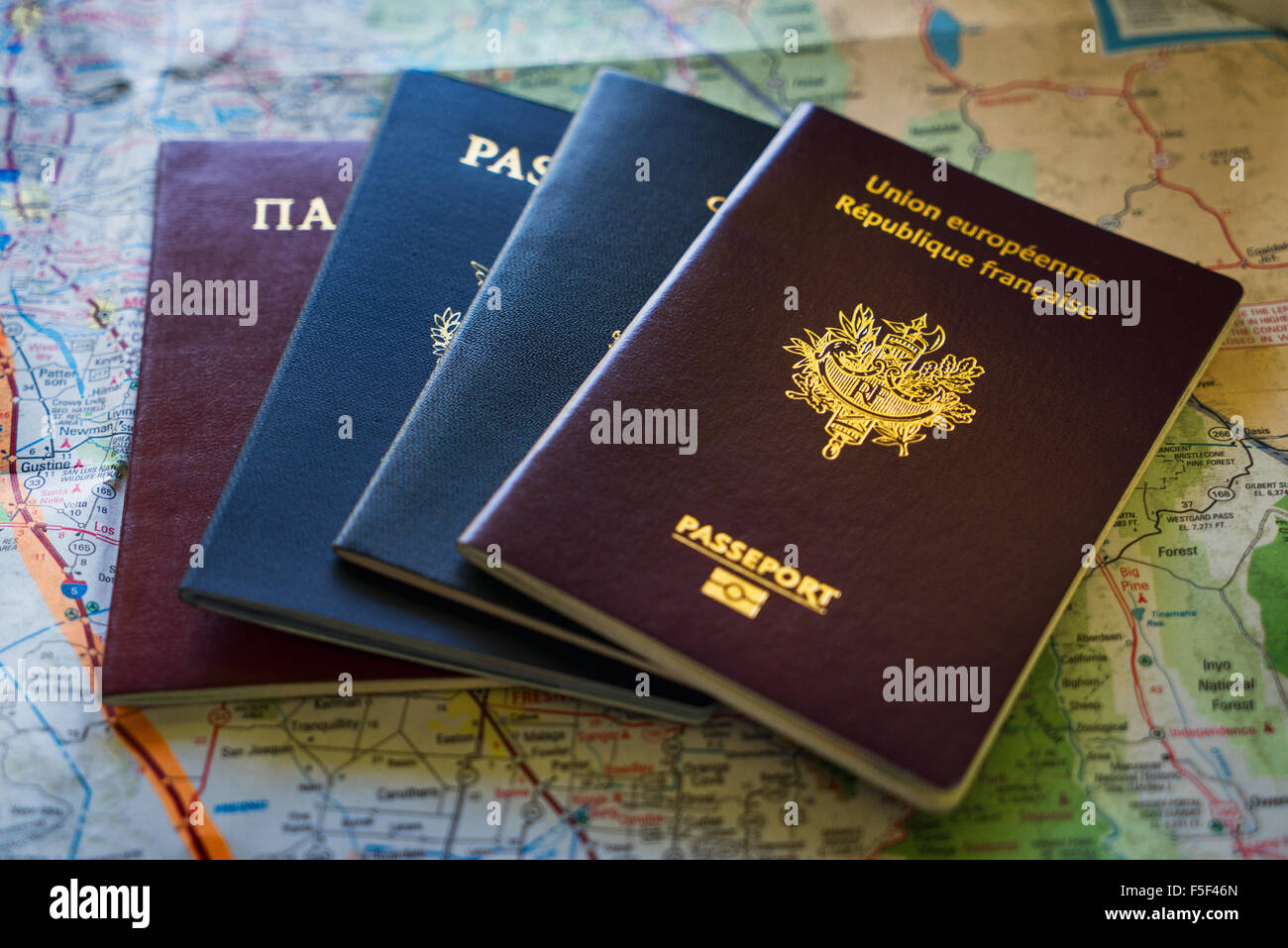 A selection of international passports sitting on a map Stock Photo
