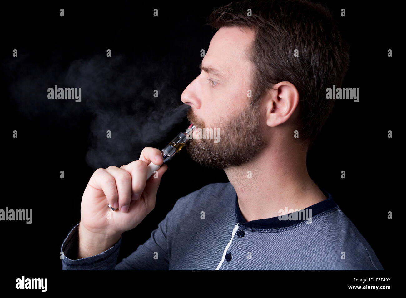 smoking electric cigarettes on the black background Stock Photo