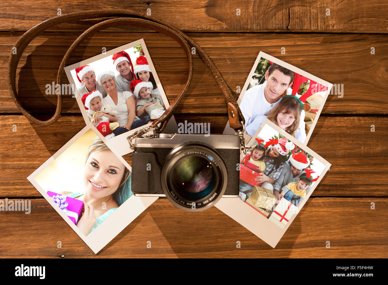 Composite image of children sitting with their family holding christmas boots Stock Photo