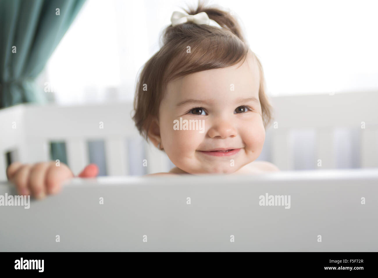 Infant baby resting and playing in his little baby bed Stock Photo Alamy