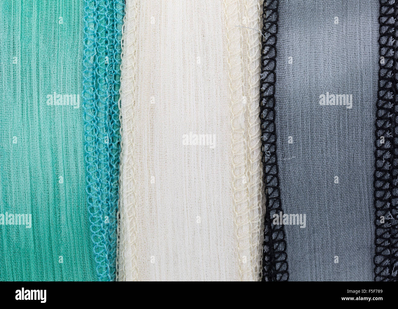 Close view of green ivory and gray polyester ribbon. Stock Photo