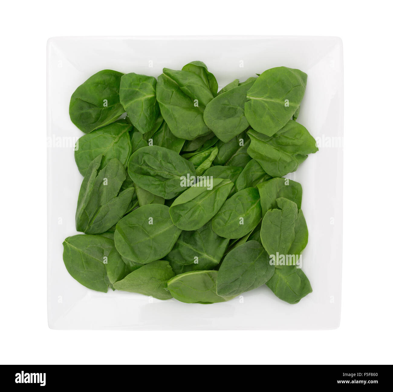 Top view of a serving of baby spinach on a square plate isolated on a