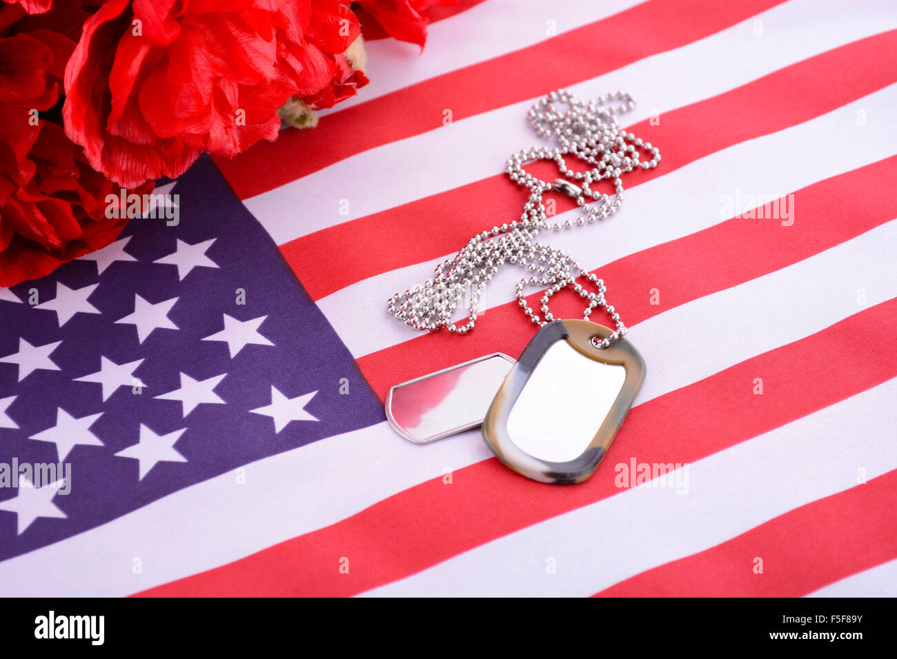 Veterans Day USA flag with dog tags and red flanders poppies on rustic ...