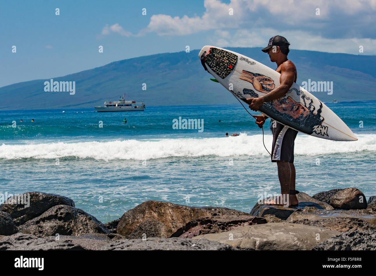 Surfer at Lahaina Harbor, Maui, Hawaii, Molokai in background Stock Photo
