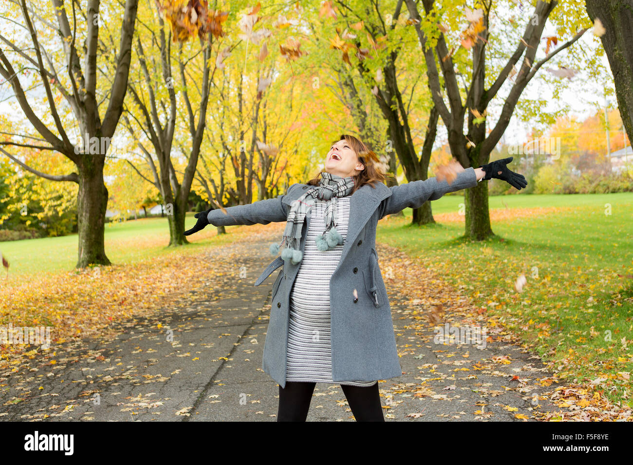 Beautiful pregnant woman in the autumn park Stock Photo - Alamy