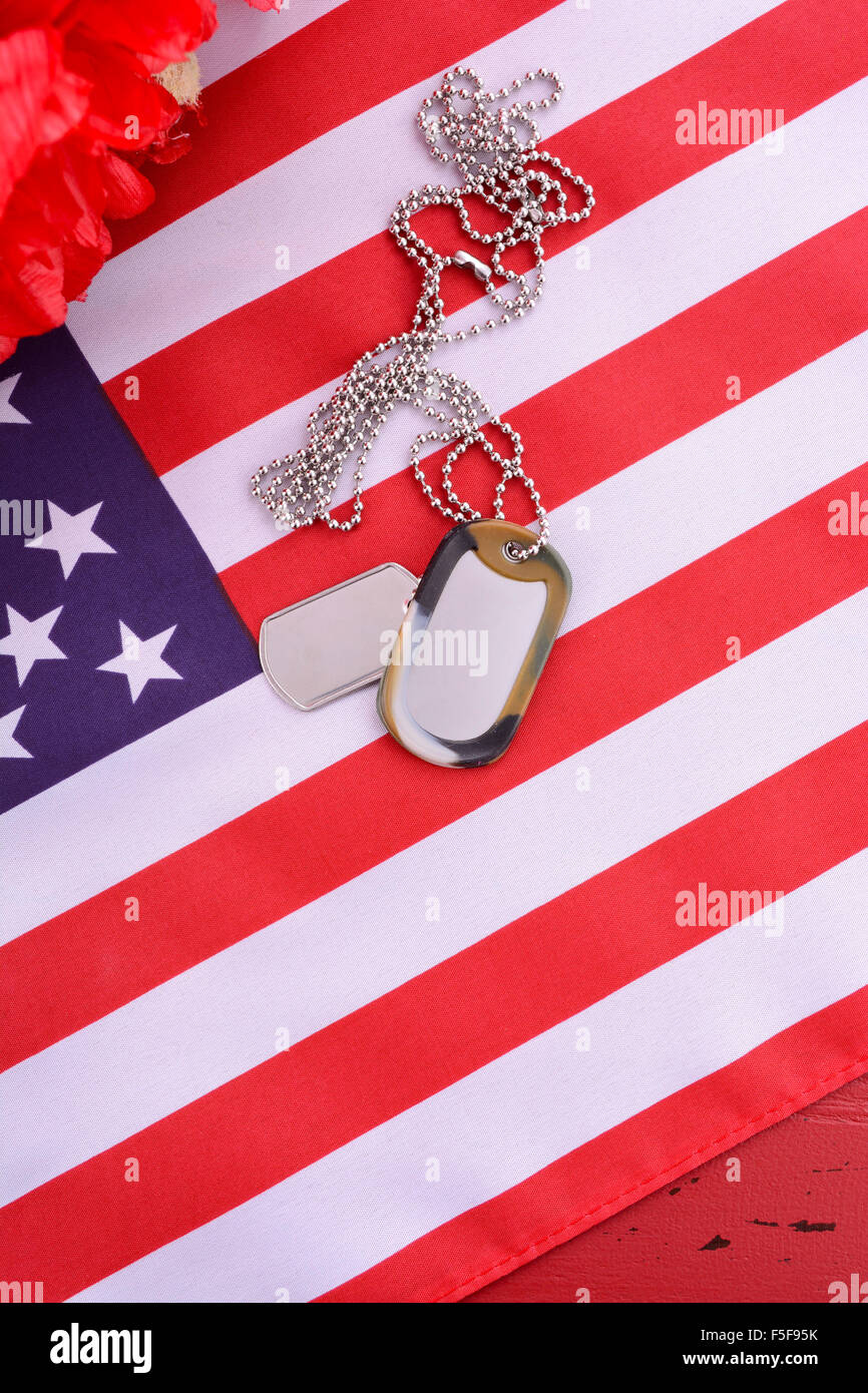 Veterans Day USA flag with dog tags and red flanders poppies on rustic ...