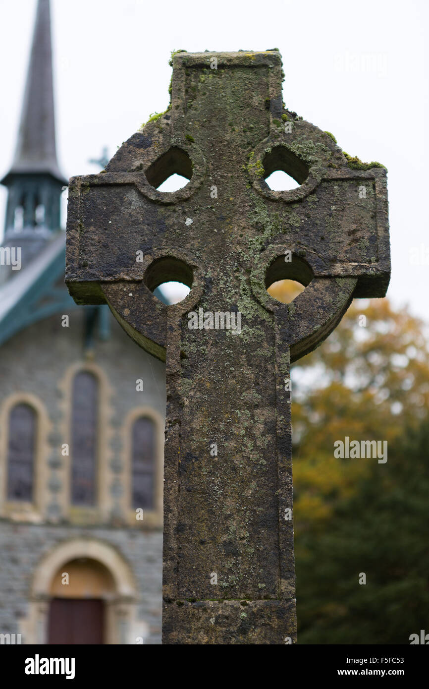 A stone Celtic Cross outside Holy Trinity Church, in the parish of Llanegwad, Pontargothi Stock Photo