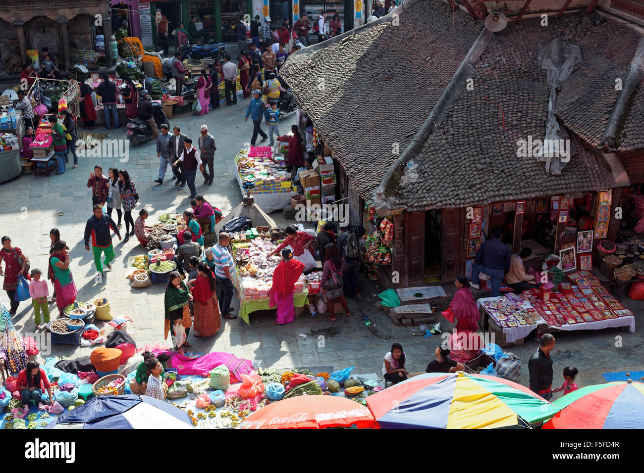 Kathmandu, Nepal - November 2, 2013: buyers and sellers at a busy street market in Kathmandu with groceries, fruits and clothes Stock Photo