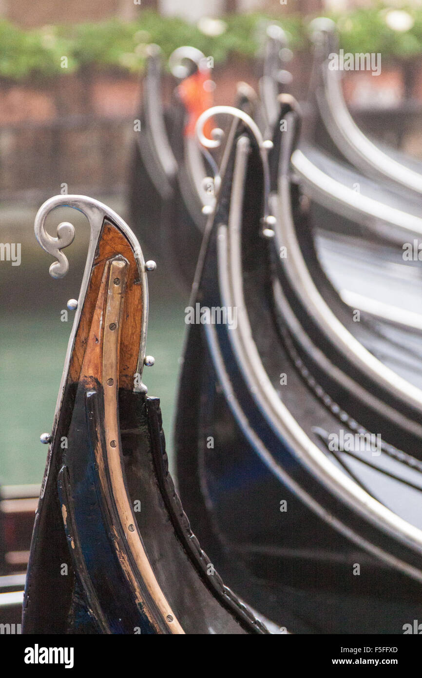 Metal parts on the back of a gondola called the risso. Many gondolas parked close together in a lagoon off the Grand Canal in Venice, Italy. Stock Photo