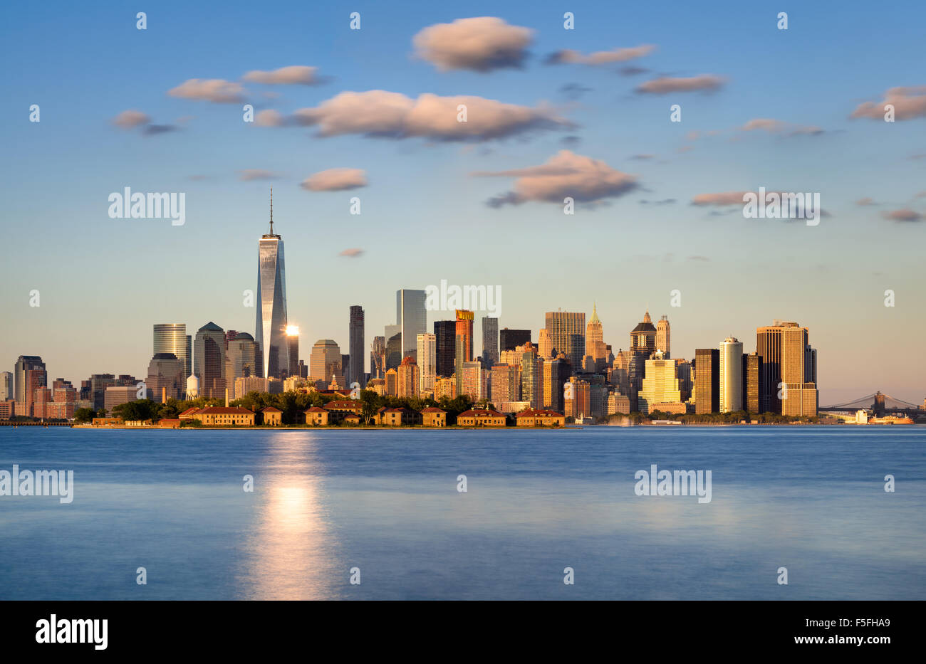 Skyline of New York City, Lower Manhattan. Ellis Island appears in front of the Financial District’s skyscrapers Stock Photo