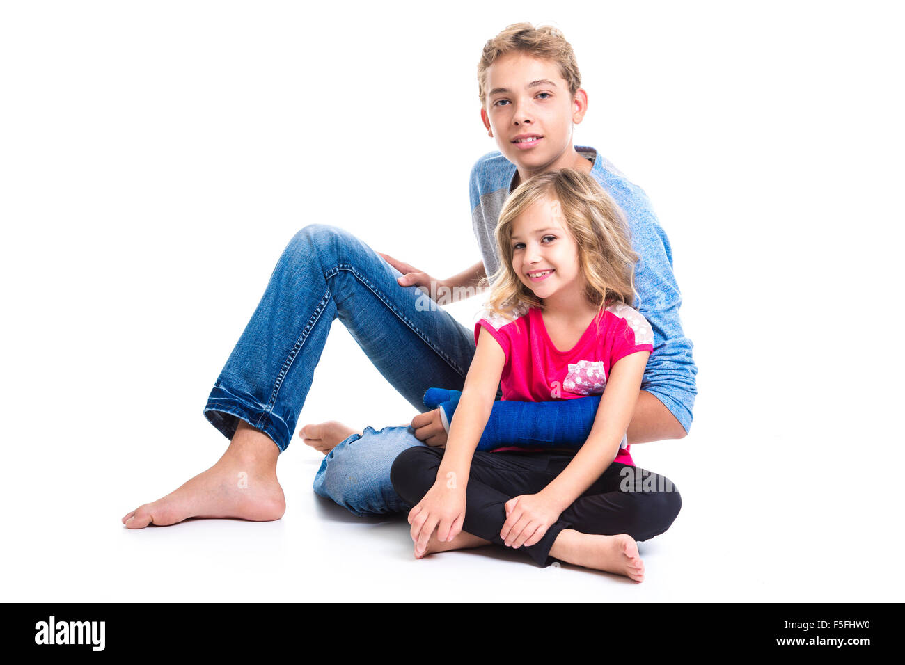 beautiful children teenager boy with is young sister Stock Photo