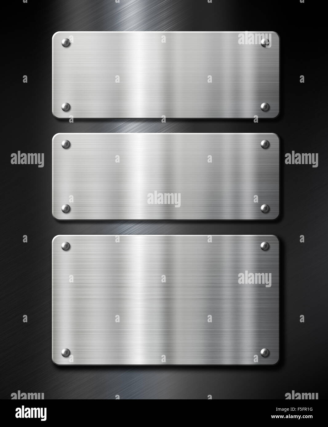 stainless steel metal plates on black brushed background Stock Photo