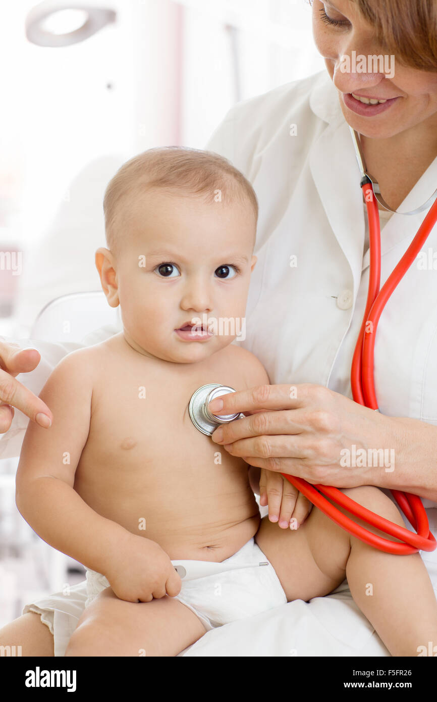 pediatrician doctor with baby in medical room Stock Photo