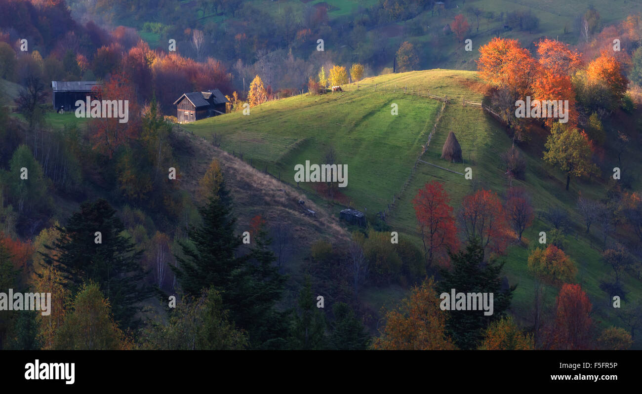 Amazing rural scene on autumn valley. Small mountain village in fantastic morning sunlight. Carpathians, Ukraine, Europe. Stock Photo
