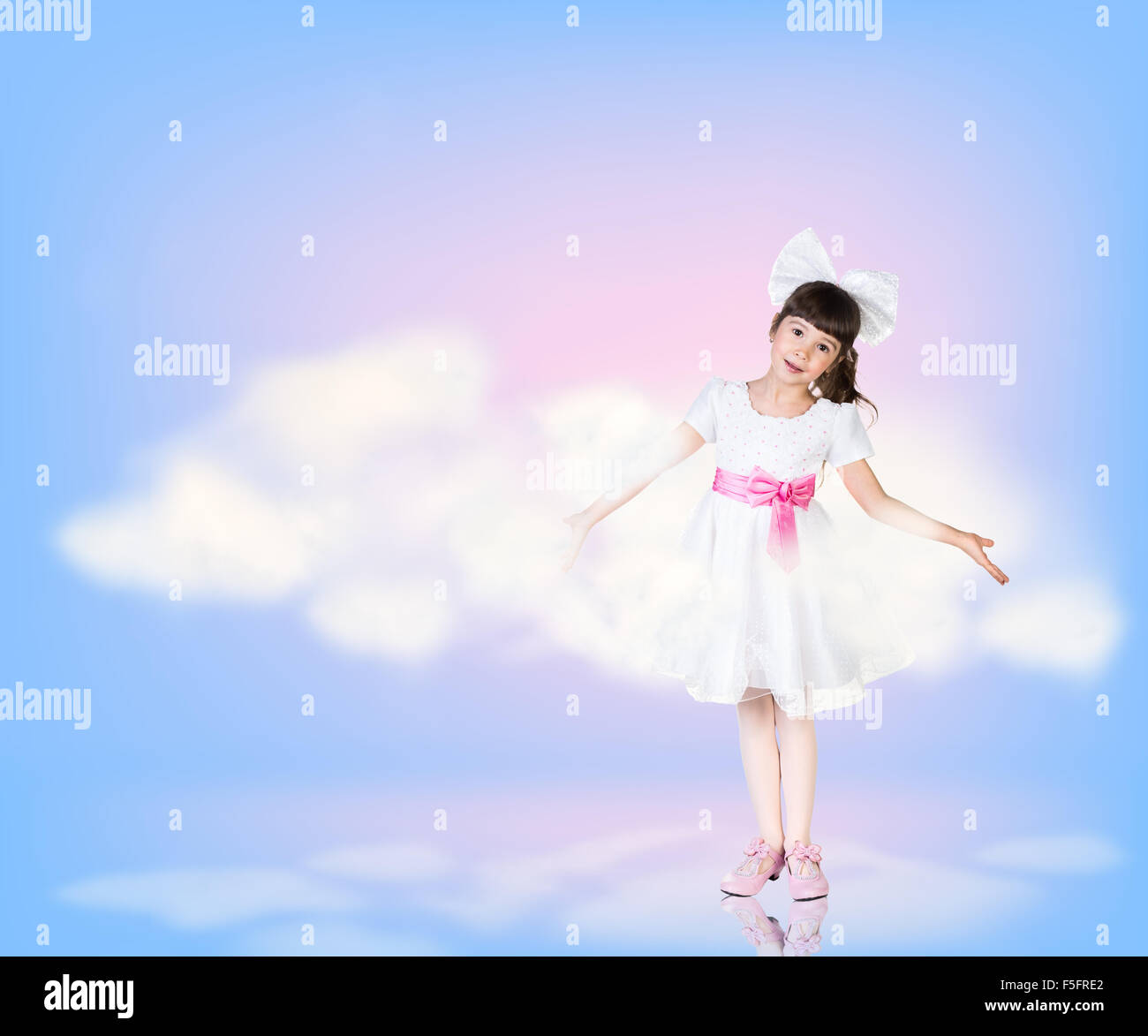 Cute little girl in blue sky with clouds Stock Photo - Alamy