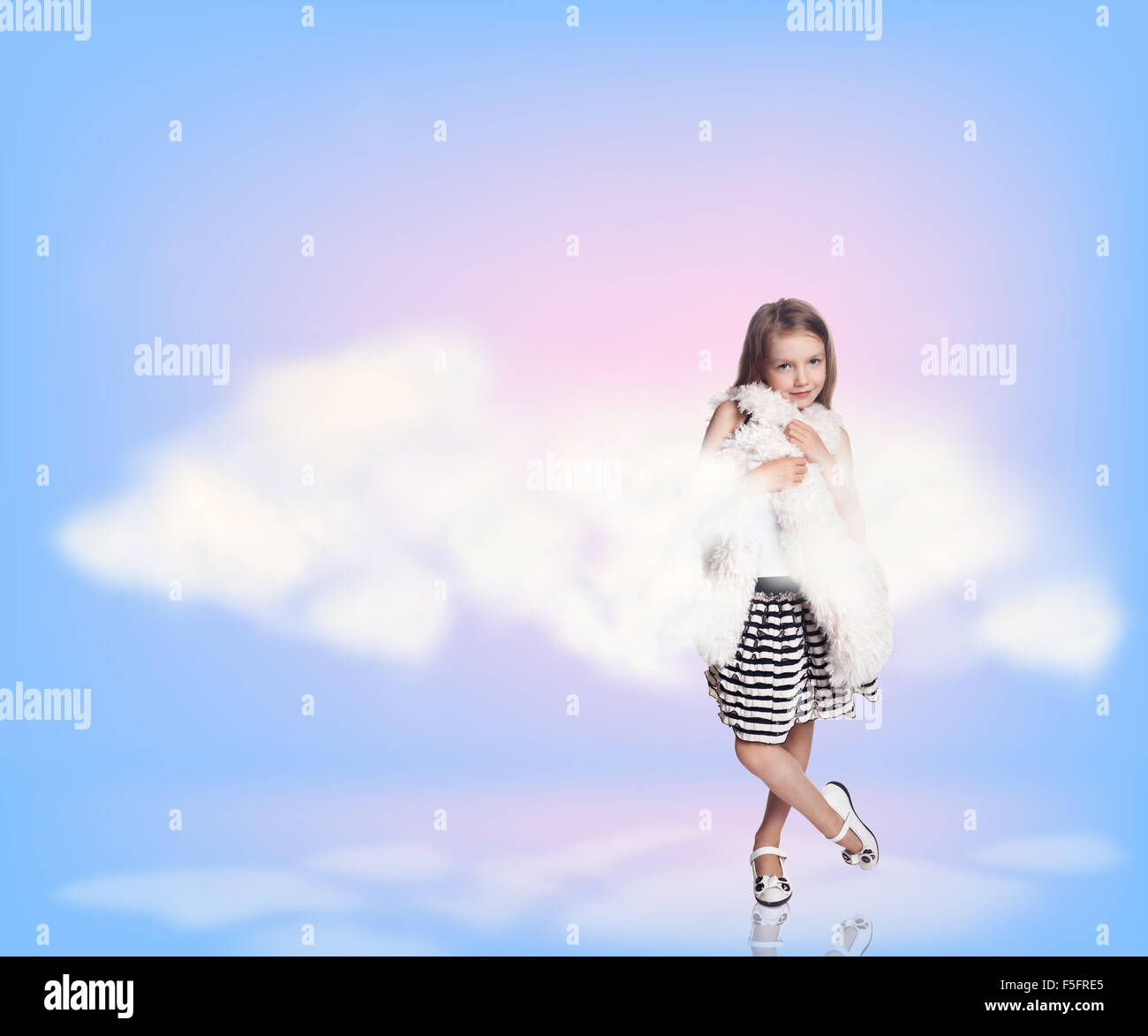 Cute little girl in blue sky with clouds Stock Photo - Alamy