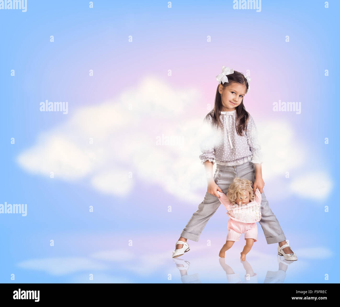 Cute little girl in blue sky with clouds Stock Photo - Alamy