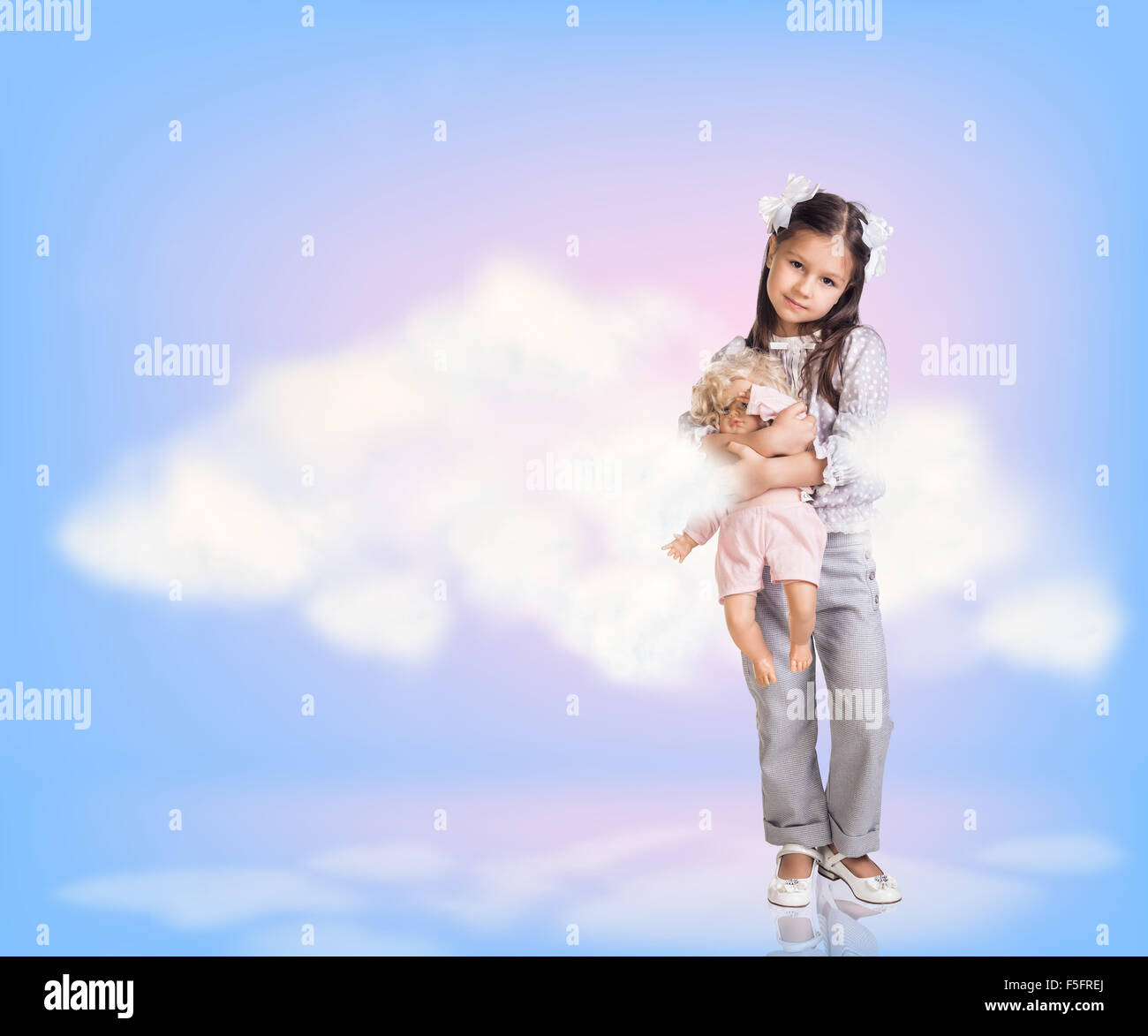 Cute little girl in blue sky with clouds Stock Photo - Alamy