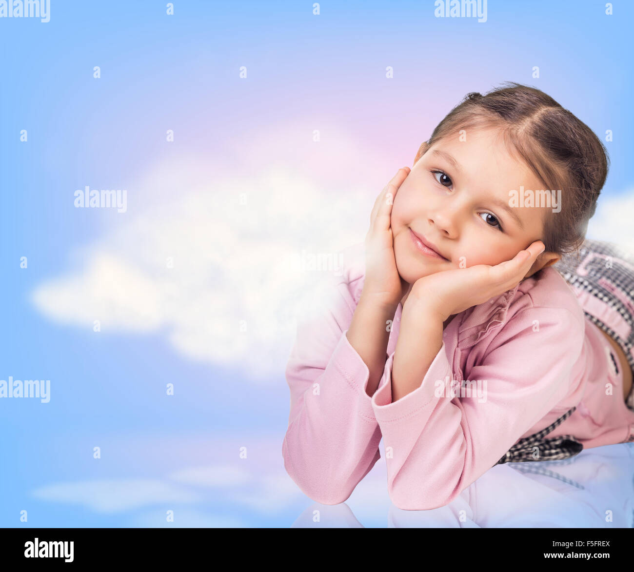 Cute little girl in blue sky with clouds Stock Photo - Alamy