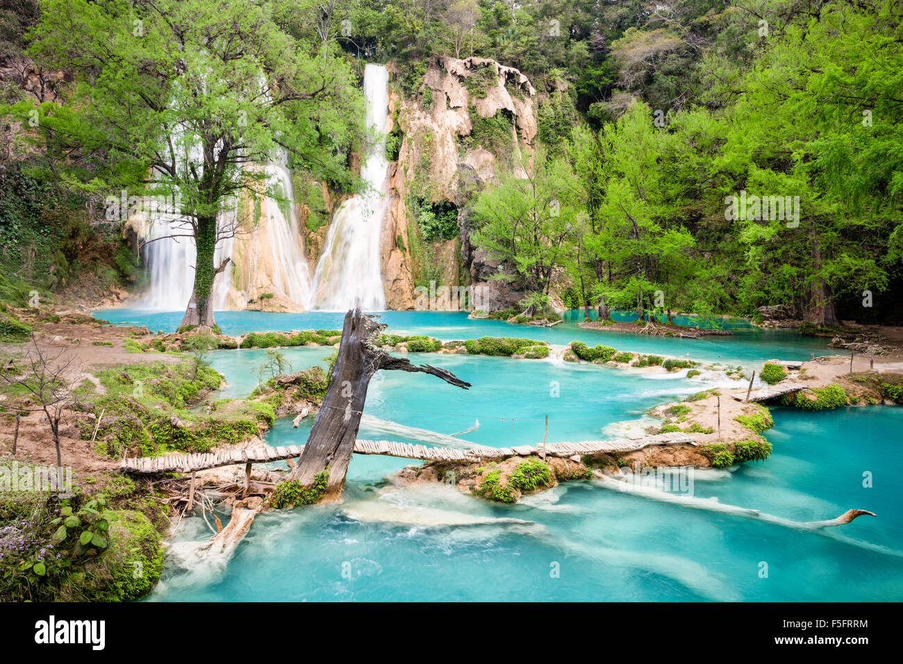 Azure water flows beneath the Minas Viejas Falls in San Luis Potosi, Mexico. Stock Photo