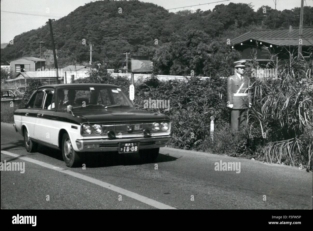 1972 - Dummy Cops Slow Speedsters In Japan: Life like models of Japanese traffic policeman placed, near zebra-crossings, intersections, and Country roads, to deter traffic Violators, and slow down speedsters, are found to be very effective, as they look so real to approaching drivers hart he or she is uncertain id it is a live cop, or dummy, Because for the uncertainty the pressure on the accelerator is lifted, and the car or truck slows down, and that is the whole idea behind the dummy cop. On Country roadsm, the dummy cop is sometimes place in a held concealed spot behind bushes on the side Stock Photo