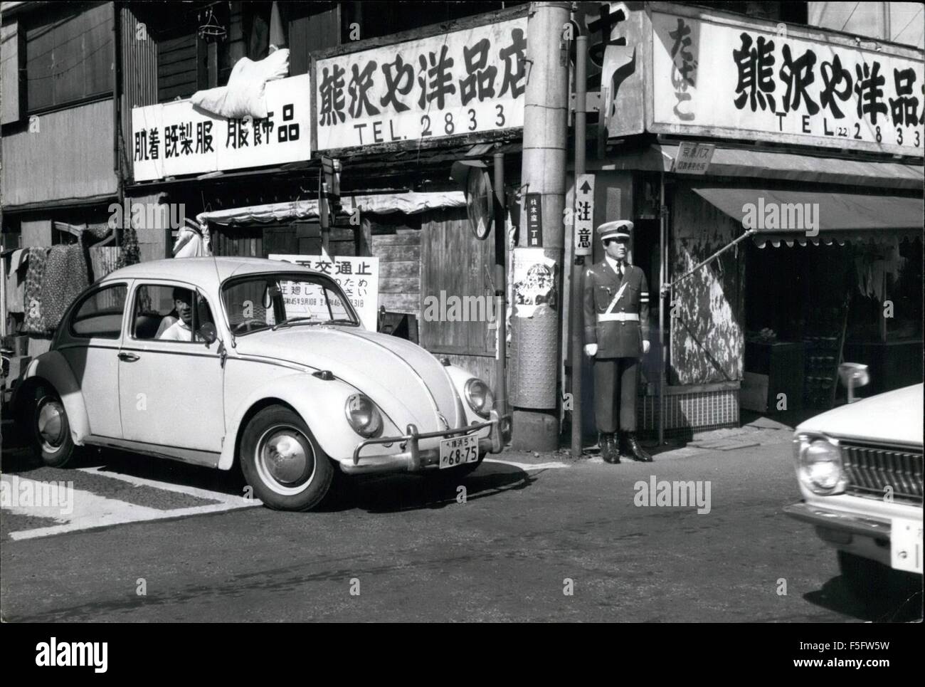 1972 - Dummy cops slow speedsters in Japan.: Lifelike models of Japanese traffic policemen placed near zebra-crossings, intersections, and country roads, to deter traffic violators, and slow down speedsters, are found to be very effective, as they look so real to approaching drivers that he or she is uncertain if it is a live cop, of a dummy. Because of the uncertainty the pressure on the accelerator is lifted, and the car or trucks slows down, and that is the whole idea behind the dummy cop. On country roads, the dummy cop is sometimes placed in a half-concealed spot behind bushes on the side Stock Photo