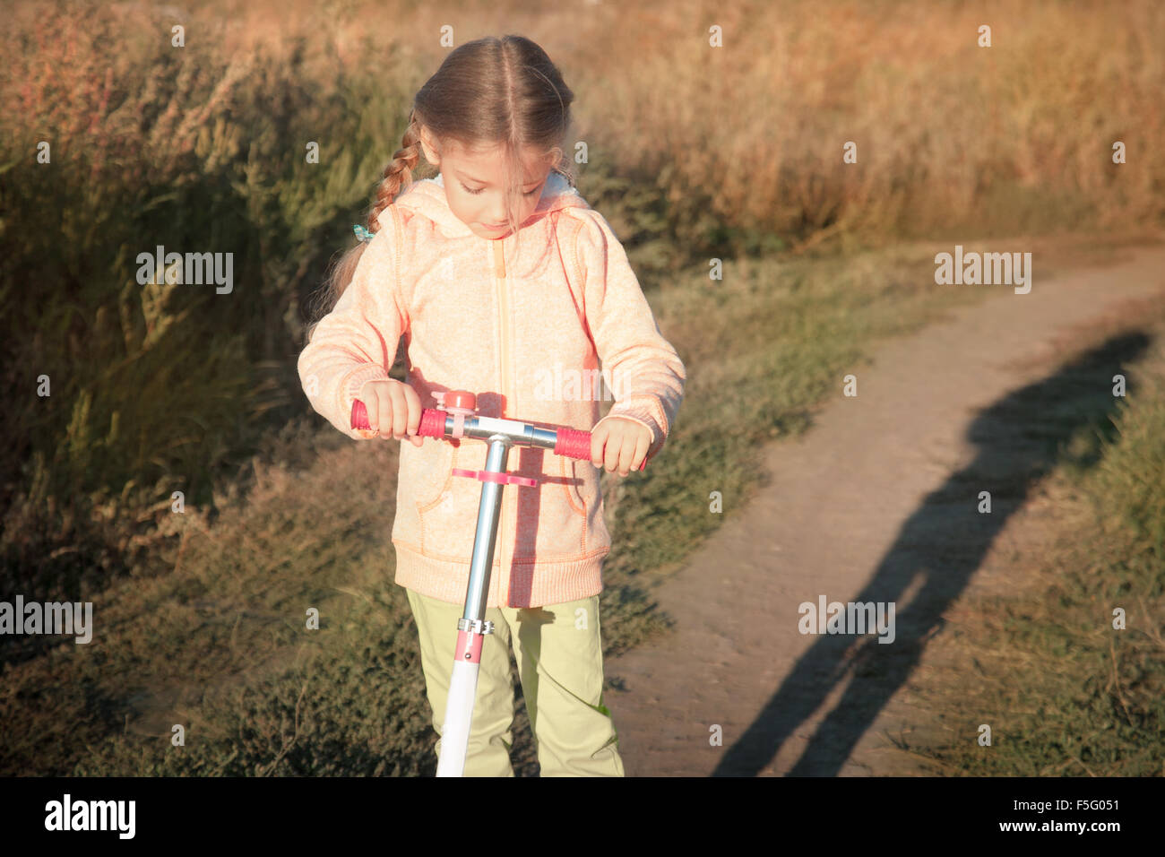 Beautiful girl driving scooter on rural road Stock Photo Alamy