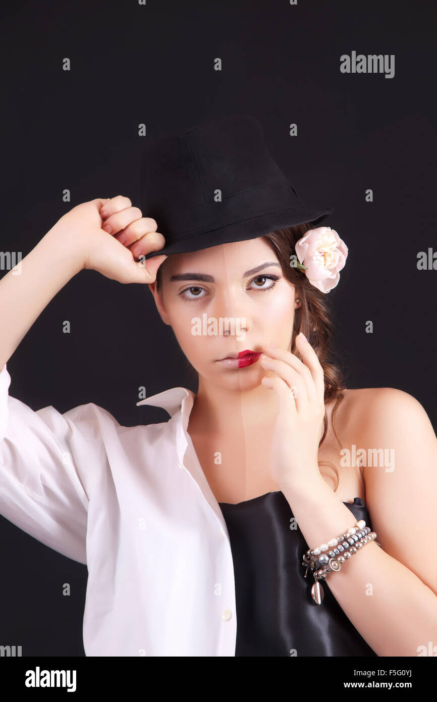 Portrait of the woman with a theatrical makeup on black background Stock Photo